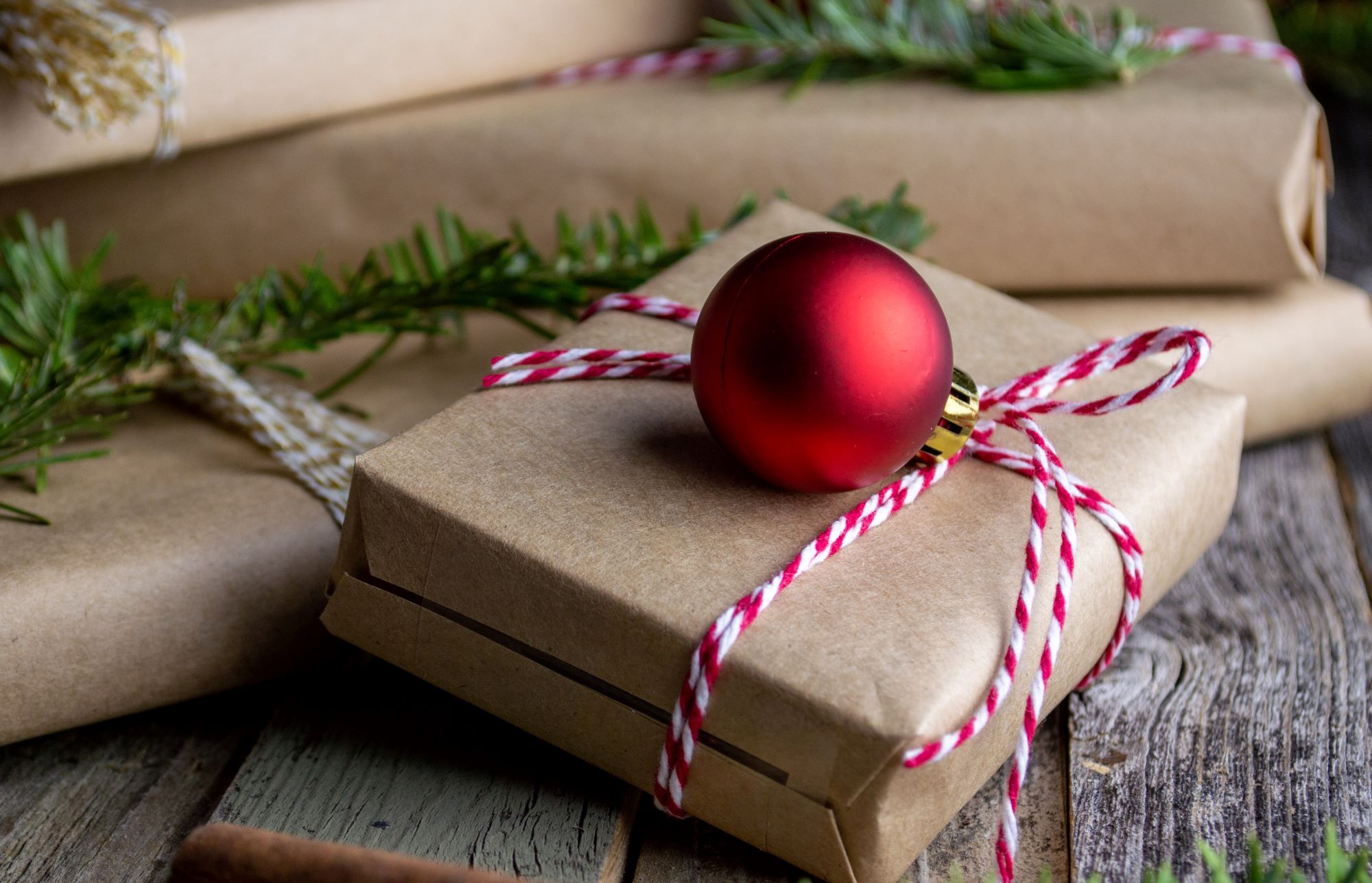 A gift wrapped in brown paper and red string